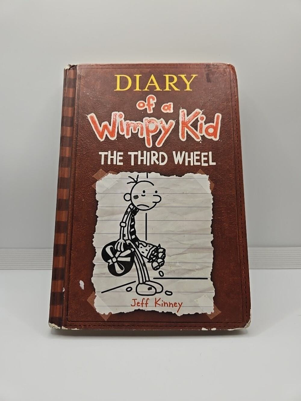 DIARY OF A WIMPY KID: THE THIRD WHEEL by Jeff Kinney a Hardcover book